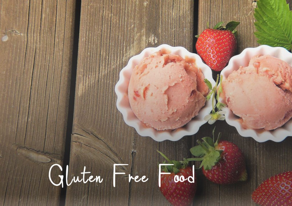 Gluten free food - strawberries and ice cream in white bowls on a table