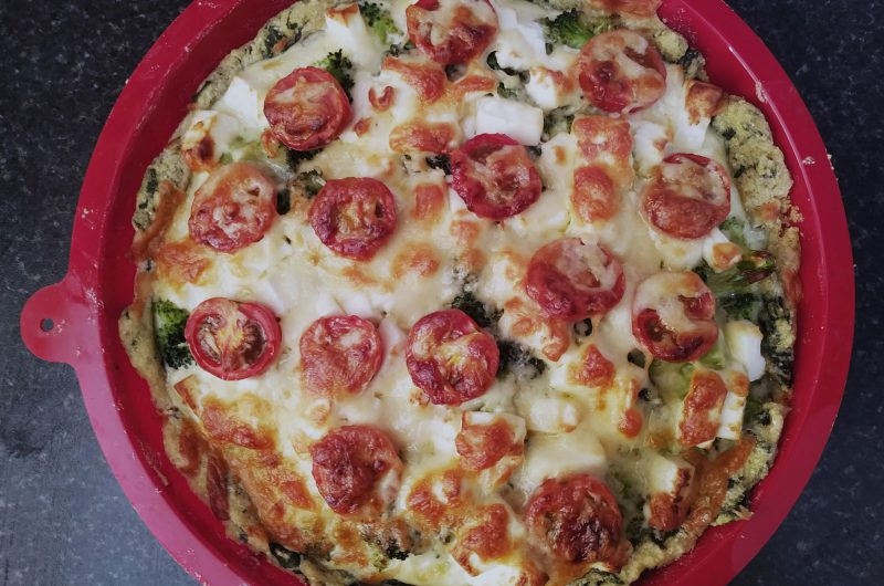 Broccoli pie with feta cheese on a spinach crust