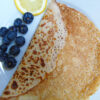 Pancake on a plate with blueberries and lemon