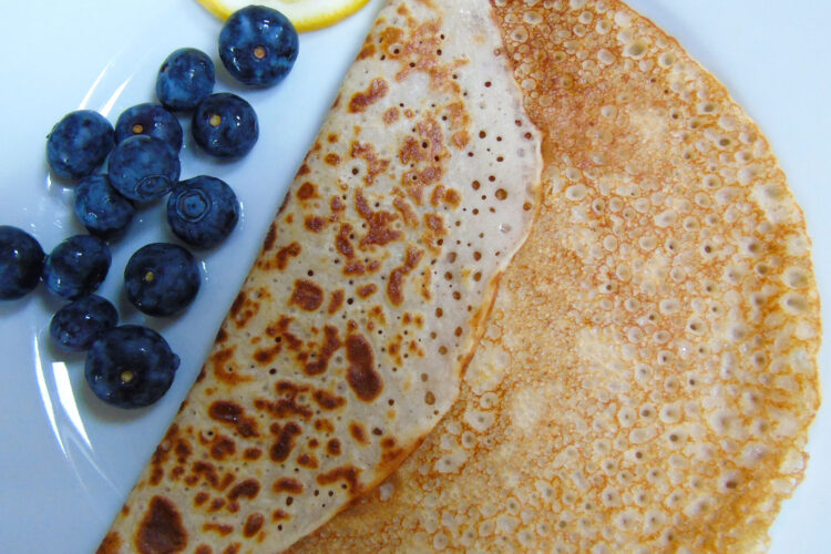 Pancake on a plate with blueberries and lemon