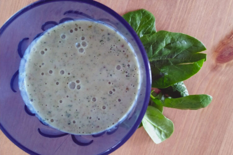 Green smoothie in a blue glass