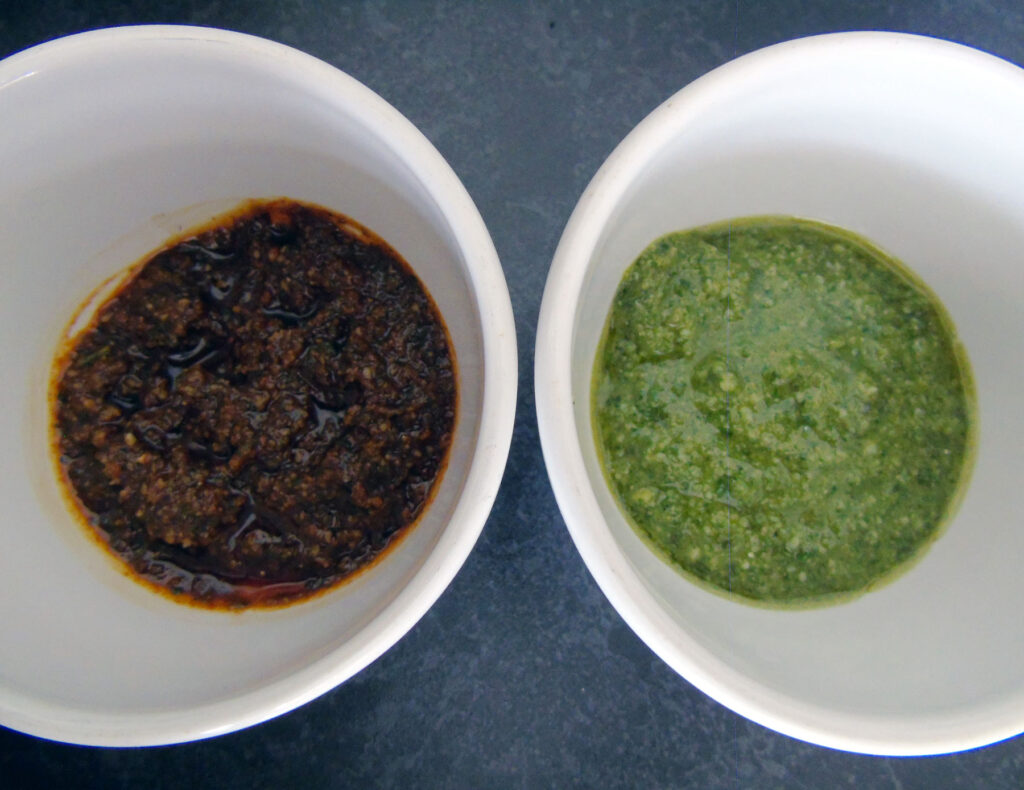 Red and green pesto in small bowls