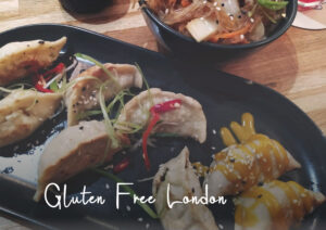 Dumplings and noodles on a plate with text Gluten Free London in the foreground