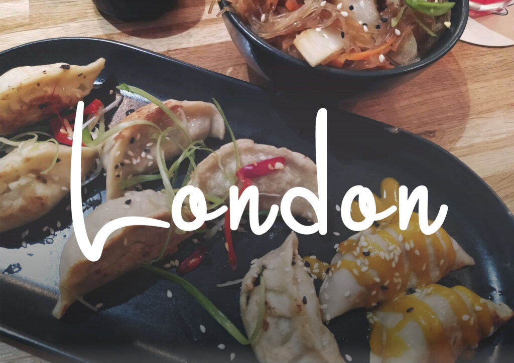 Dumplings and noodles on a table with text London in the foreground