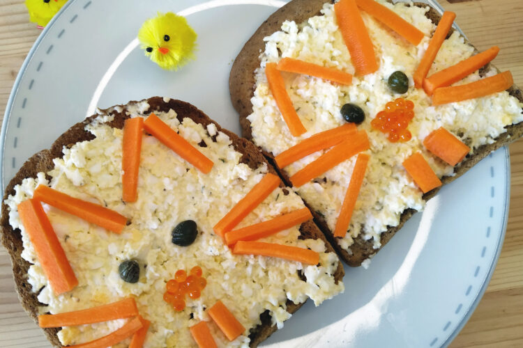 Two open sandwiches with decorations and egg mayo