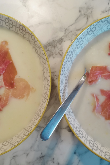 Two bowls of melon soup on counter